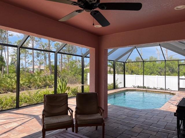 7286 Mineola Rd, Englewood, FL 34224 - view of swimming pool with a patio area, ceiling fan, and glass enclosure