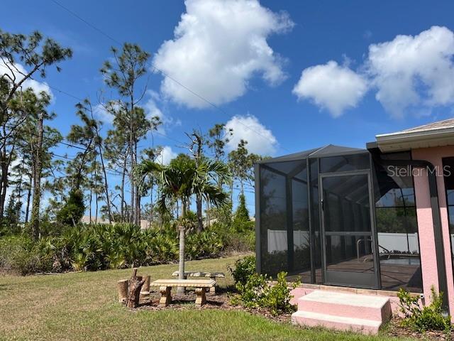 7286 Mineola Rd, Englewood, FL 34224 - view of grassy yard featuring a lanai