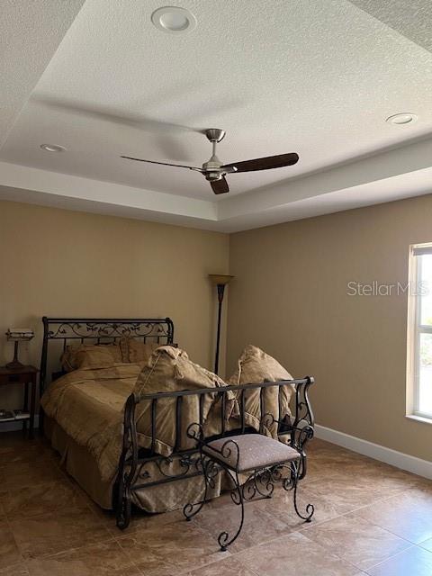 7286 Mineola Rd, Englewood, FL 34224 - bedroom with baseboards, a textured ceiling, a ceiling fan, and recessed lighting