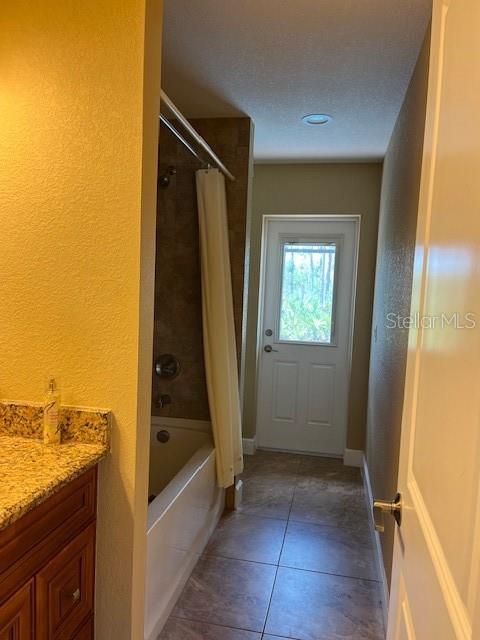 7286 Mineola Rd, Englewood, FL 34224 - bathroom featuring tile patterned flooring, shower / bath combo, vanity, and baseboards