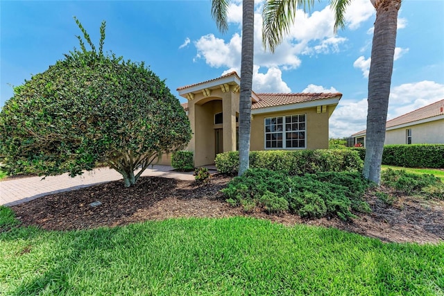 mediterranean / spanish-style home featuring stucco siding and a tiled roof