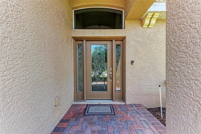 doorway to property with stucco siding