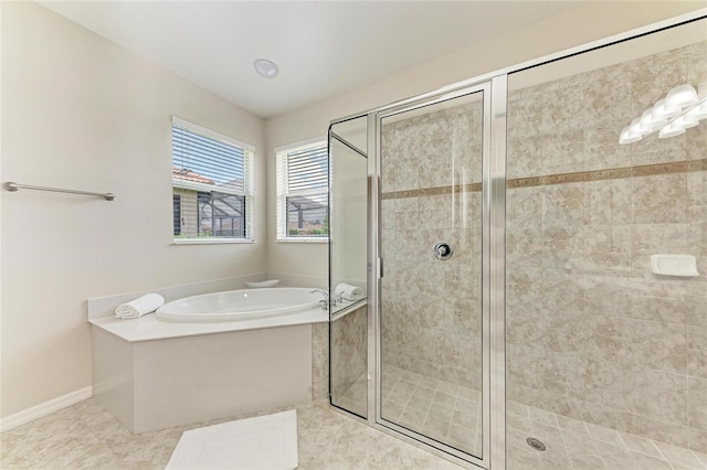 full bath featuring a stall shower, a bath, tile patterned floors, and baseboards