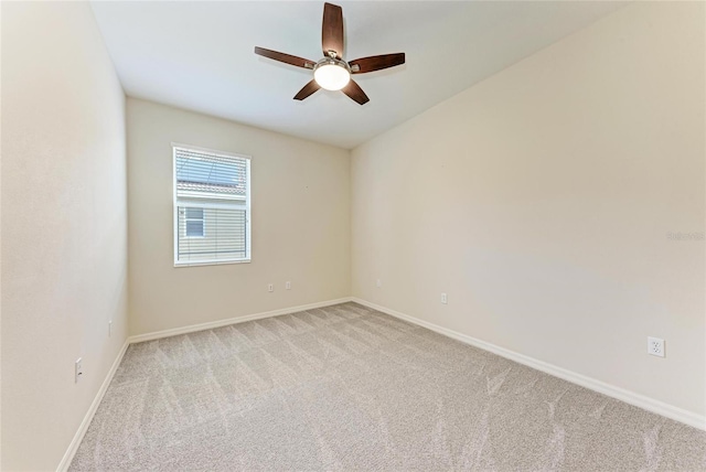 unfurnished room featuring light carpet, ceiling fan, and baseboards