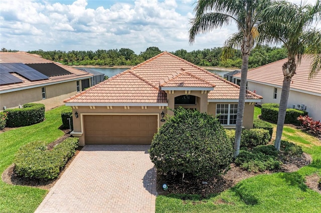 view of front of home with stucco siding, an attached garage, decorative driveway, and a tiled roof