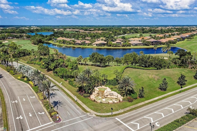 aerial view of residential area featuring a large body of water, a golf club, and a tree filled landscape