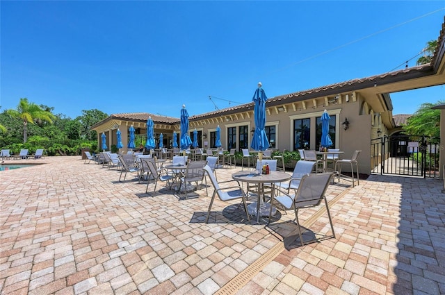 view of patio with fence and a community pool