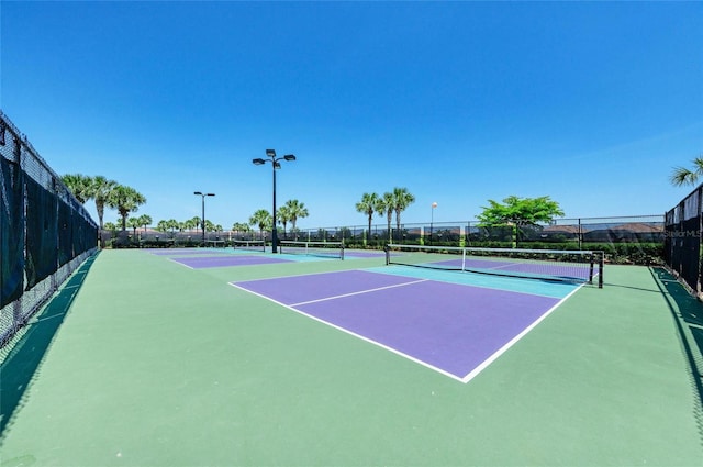 view of tennis court with fence