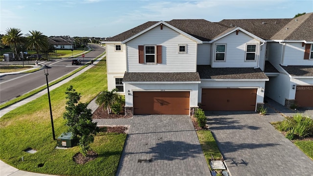 1824 Woodleaf Hammock Ct, Bradenton, FL 34211 - view of front of home with a garage, roof with shingles, and decorative driveway