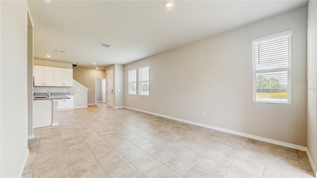 1824 Woodleaf Hammock Ct, Bradenton, FL 34211 - unfurnished living room with recessed lighting, light tile patterned floors, and baseboards