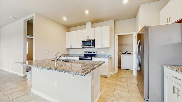 1824 Woodleaf Hammock Ct, Bradenton, FL 34211 - kitchen featuring appliances with stainless steel finishes, washer / clothes dryer, a sink, light tile patterned floors, and light stone countertops