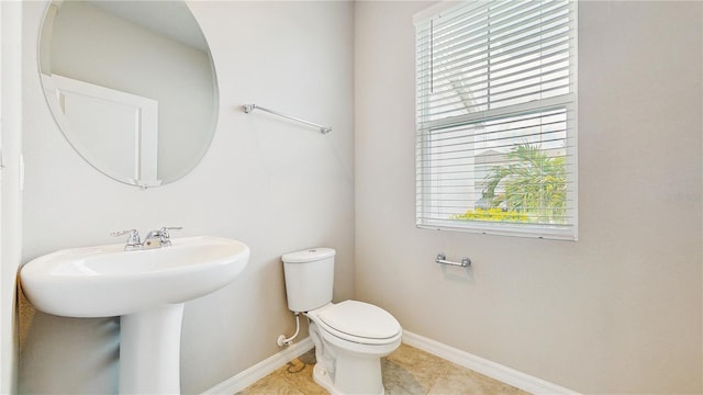 1824 Woodleaf Hammock Ct, Bradenton, FL 34211 - half bath featuring toilet, baseboards, tile patterned flooring, and a sink