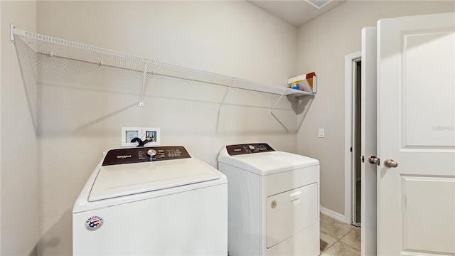 1824 Woodleaf Hammock Ct, Bradenton, FL 34211 - clothes washing area featuring washing machine and dryer, light tile patterned floors, and baseboards