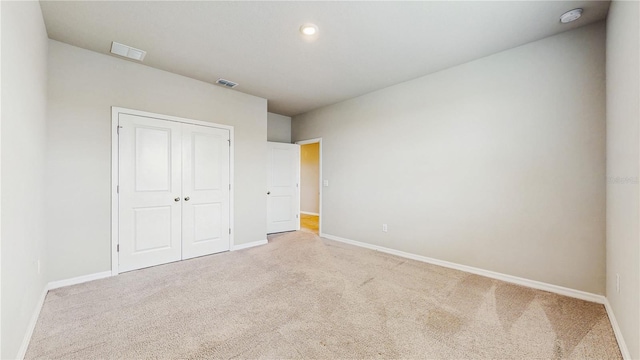 1824 Woodleaf Hammock Ct, Bradenton, FL 34211 - unfurnished bedroom with light carpet, baseboards, and a closet