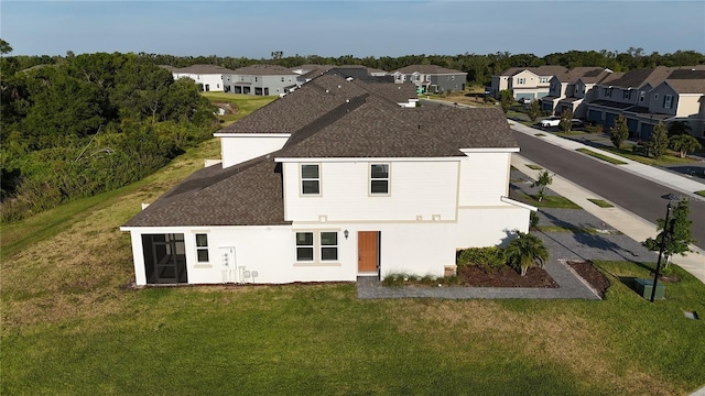 1824 Woodleaf Hammock Ct, Bradenton, FL 34211 - back of house featuring roof with shingles, a residential view, and a lawn