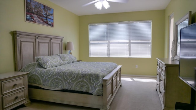 carpeted bedroom with baseboards and a ceiling fan