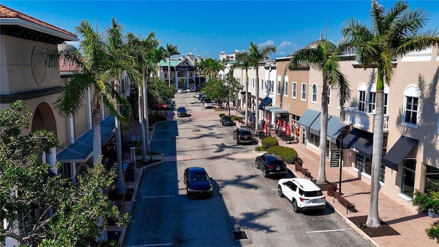 view of asphalt street featuring a residential view, curbs, and sidewalks