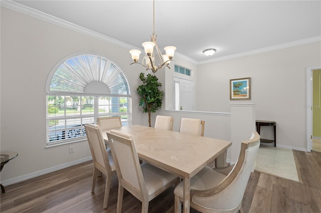 7424 Arrowhead Run, Lakewood Ranch, FL 34202 - dining area with a chandelier, crown molding, wood finished floors, and baseboards