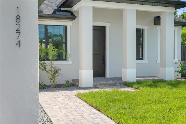 18274 Grace Ave, Port Charlotte, FL 33948 - doorway to property with stucco siding