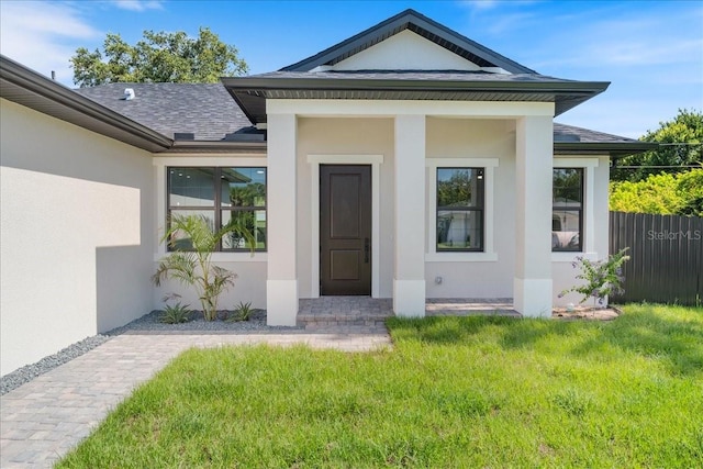 18274 Grace Ave, Port Charlotte, FL 33948 - property entrance featuring stucco siding and roof with shingles