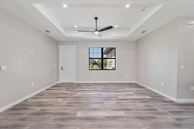 18274 Grace Ave, Port Charlotte, FL 33948 - unfurnished room with a raised ceiling, light wood-style flooring, ceiling fan, recessed lighting, and a smoke detector