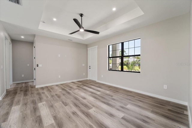 18274 Grace Ave, Port Charlotte, FL 33948 - spare room featuring a raised ceiling, light wood-type flooring, a ceiling fan, and recessed lighting