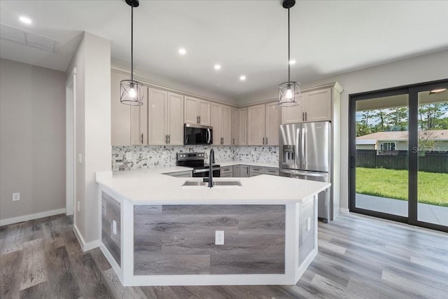 18274 Grace Ave, Port Charlotte, FL 33948 - kitchen featuring appliances with stainless steel finishes, tasteful backsplash, light countertops, a peninsula, and light wood finished floors