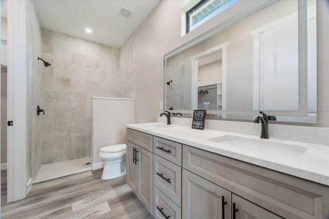 18274 Grace Ave, Port Charlotte, FL 33948 - full bath with double vanity, tiled shower, wood finished floors, and a spacious closet