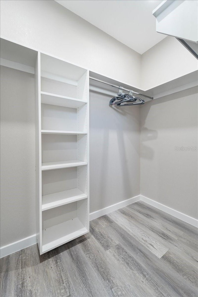 18274 Grace Ave, Port Charlotte, FL 33948 - walk in closet featuring wood finished floors