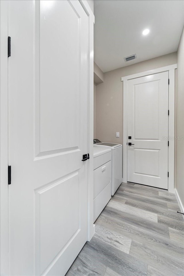 18274 Grace Ave, Port Charlotte, FL 33948 - entryway featuring washer and clothes dryer, light wood finished floors, and recessed lighting