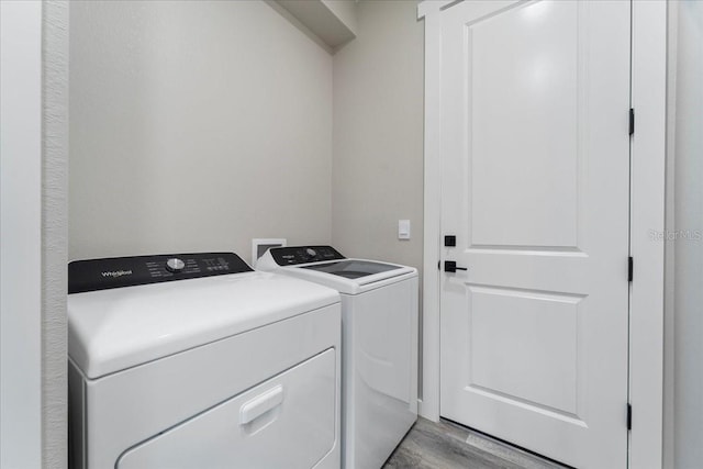 18274 Grace Ave, Port Charlotte, FL 33948 - washroom with washer and dryer and light wood finished floors