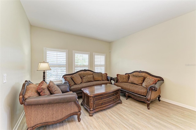 living area with baseboards and light wood-style floors