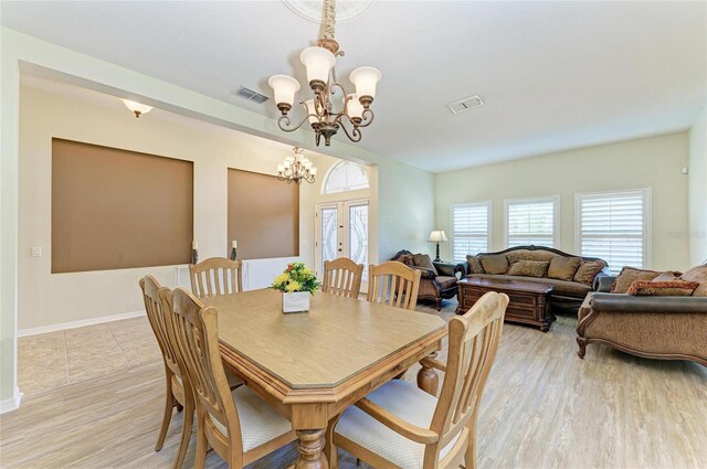 dining room with a chandelier and light wood finished floors