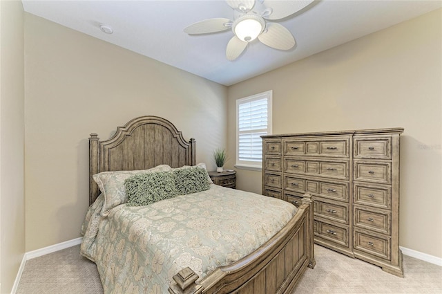 bedroom featuring light carpet, baseboards, and a ceiling fan