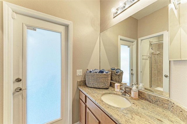 full bathroom featuring a stall shower and vanity