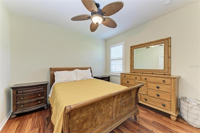 bedroom featuring wood finished floors, ceiling fan, and baseboards