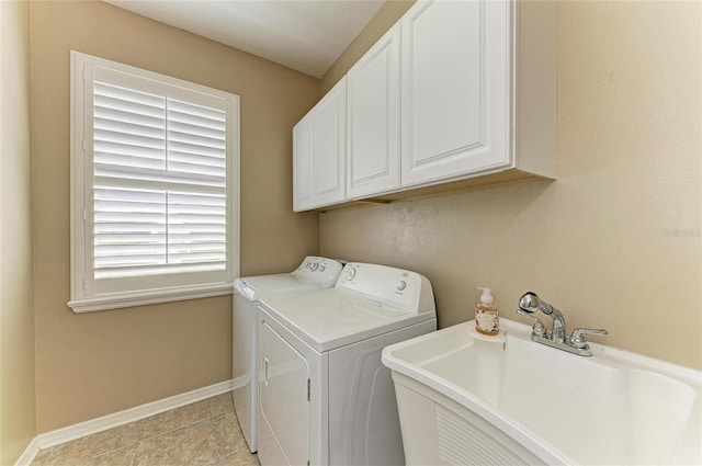 laundry area with washer and clothes dryer, cabinet space, and baseboards