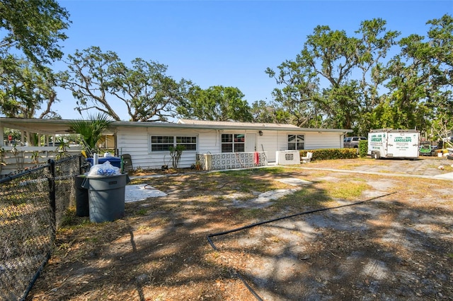 rear view of property featuring fence