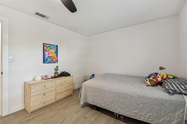 bedroom with light wood-type flooring, baseboards, visible vents, and a ceiling fan
