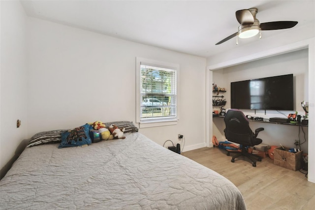 bedroom with a ceiling fan and light wood-style floors
