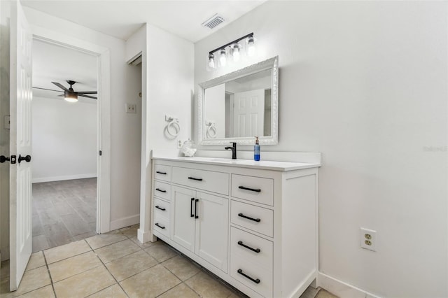 bathroom with visible vents, tile patterned flooring, baseboards, ceiling fan, and vanity