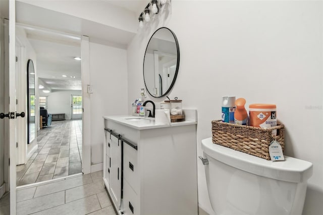 bathroom featuring tile patterned floors, toilet, vanity, and recessed lighting