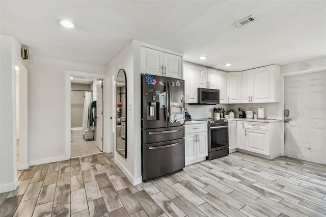 kitchen with appliances with stainless steel finishes, visible vents, wood tiled floor, and recessed lighting