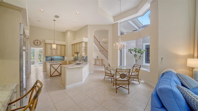 3521 Fair Oaks Ln, Longboat Key, FL 34228 - kitchen featuring open floor plan, a high ceiling, baseboards, light tile patterned floors, and recessed lighting