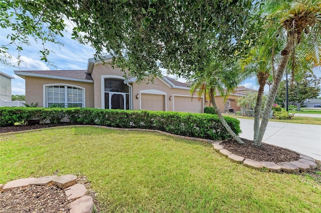 4211 30th Ln E, Bradenton, FL 34208 - view of front facade featuring a garage, stucco siding, and a front lawn