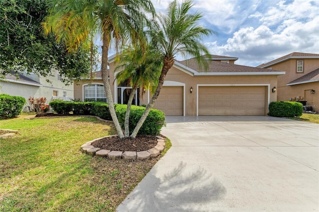 4211 30th Ln E, Bradenton, FL 34208 - view of front of house with an attached garage, stucco siding, driveway, and a front yard