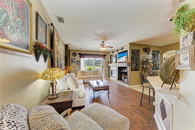 4211 30th Ln E, Bradenton, FL 34208 - living room featuring wood finished floors, a ceiling fan, a textured ceiling, visible vents, and baseboards