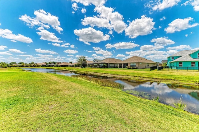 water view with fence and nearby suburban area