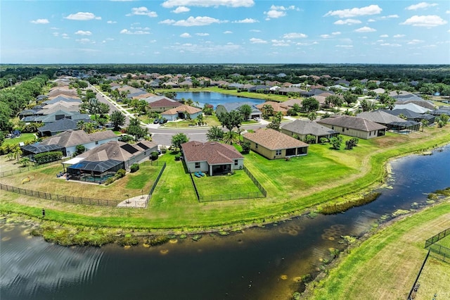 aerial view of residential area featuring a large body of water