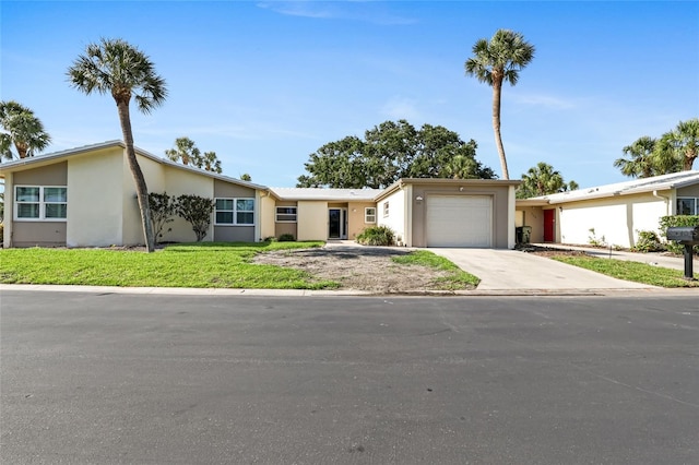 ranch-style house with a front yard, stucco siding, driveway, and a garage